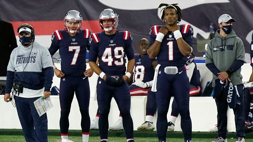 New England Patriots quarterback Cam Newton (1) watches from the sideline after being replaced by Jarrett Stidham in the second half of an NFL football game against the San Francisco 49ers, Sunday, Oct. 25, 2020, in Foxborough, Mass.