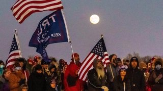 Supporters of U.S. President Donald Trump listen during a "Make America Great Again" rally at the Rochester International Airport in Rochester, Minnesota, Oct. 30, 2020.