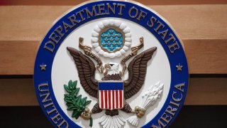 The U.S. Department of State seal is seen on the podium-lectern area, Nov. 26, 2013, in the State Department briefing room in Washington, D.C.