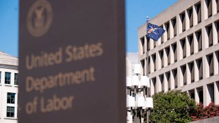 A flag flies outside the U.S. Department of Labor building in Washington, D.C., Aug. 18, 2020.