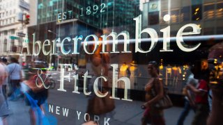 Pedestrians are reflected in the window of an Abercrombie & Fitch store in New York.