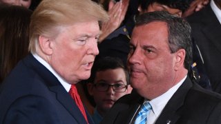 In this Oct. 26, 2017, file photo, President Donald Trump (L) speaks with Governor Chris Christie (R-NJ) after he delivered remarks on combatting drug demand and the opioid crisis in the East Room of the White House in Washington, DC.