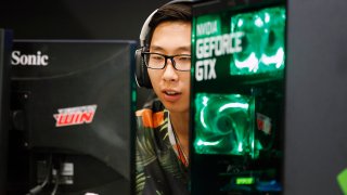 A gamer plays a video game with the Graphic card GeForce during the ‘Paris Games Week in Paris, France.