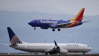 A Southwest Airlines plane lands next to a United Airlines plane