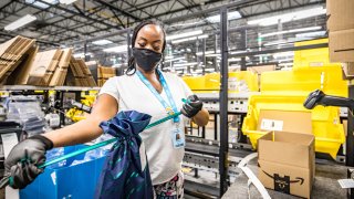 An Amazon.com Inc worker prepares an order in which the buyer asked for an item to be gift wrapped at a fulfillment center in Shakopee, Minnesota, U.S., November 12, 2020.