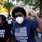People gathered in Black Lives Matter Plaza react to the presidential race being called in Joe Biden's favor, Saturday, Nov. 7, 2020, in Washington, D.C.. Democrat Joe Biden has defeated President Donald Trump to become the 46th president of the United States.