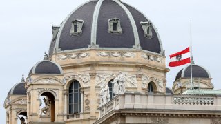 The Austrian national flag waves of half-mast on a building downtown in Vienna, Austria, Wednesday, Nov. 4, 2020. Several shots were fired shortly after 8 p.m. local time on Monday, Nov. 2, in a lively street in the city center of Vienna.