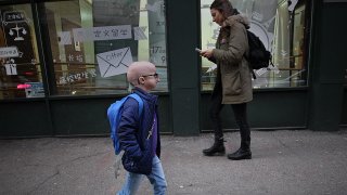 Meghan Waldron, a freshman at Emerson College, walks on the street in Boston on Feb. 12, 2020. She has progeria, one of the world's rarest diseases. It causes premature aging and typically kills kids by the age of 14. She's almost 19, and she credits lonafarnib, an experimental drug she's been taking since 2007 as part of a clinical trial at Boston Children's Hospital.