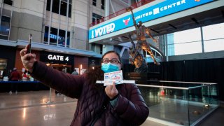 Gina Barba takes a selfie after casting her ballot in front of a Michael Jordan statue at the United Center on Election Day