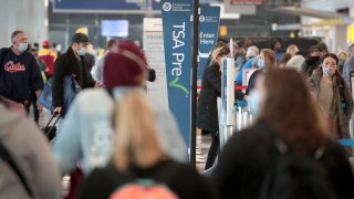 Passengers enter a Transportation Security Administration (TSA) checkpoint at O'Hare International Airport