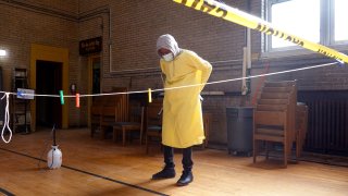 A workers gets prepared to help residents perform COVID-19 tests at a test site run by CORE at St. Benedict the African Catholic Church in the Englewood neighborhood