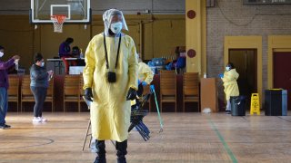 A worker helps residents perform COVID-19 tests at a test site run by CORE at St. Benedict the African Catholic Church in the Englewood neighborhood