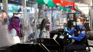 Travelers check in with TSA at O'Hare International Airport on November 25, 2020, in Chicago, Illinois. Although airports are expecting fewer than half the number of travelers from Thanksgiving 2019, they are anticipating the largest number of travelers since March when the COVID-19 pandemic became widespread in the United States.