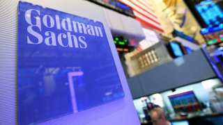 A Goldman Sachs sign is seen on at the company’s post on the floor of the New York Stock Exchange.