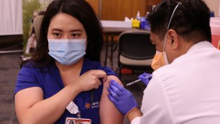 Nurse practitioner Hope Alfonso, 34, is given the Pfizer coronavirus disease (COVID-19) vaccine at Dignity Health Glendale Memorial Hospital and Health Center in Glendale, California, December 17, 2020.