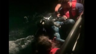 A diver who reported spending 10 hours drifting in water after being separated from his boat in the Florida Keys is rescued by the Coast Guard on Dec. 18, 2020.