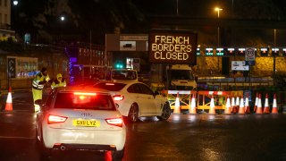 Police and port staff turn away vehicles from the Port of Dover in Kent, England which has been closed after the French government's announcement, Monday, Dec. 21, 2020. France banned all travel from the United Kingdom for 48 hours from midnight Sunday, including trucks carrying freight through the tunnel under the English Channel or from the port of Dover on England's south coast.