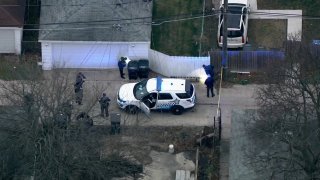 Chicago police examine an alley in the city's Fernwood neighborhood after a teen was shot on Dec. 7