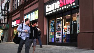 Pedestrians pass a GameStop store in New York.
