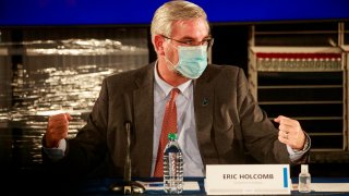 BLOOMINGTON, INDIANA, UNITED STATES – 2020/12/15: Indiana Governor Eric Holcomb wearing a face mask speaks during a round table discussion at Catalent Biologics, where COVID vaccine vials are being filled. (Photo by Jeremy Hogan/SOPA Images/LightRocket via Getty Images)