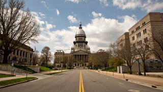 The Illinois State Capitol building stands among empty streets in Springfield, Illinois on April 9, 2020.