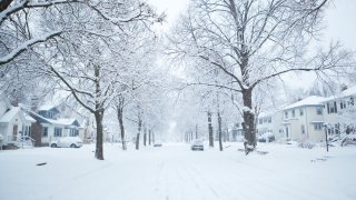 Subject: A winter snow storm in a residential area of the city.