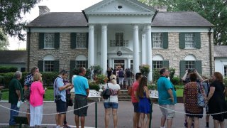 Visitors queue to enter the Graceland mansion of Elvis Presley