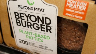 FILE - In this June 27, 2019, file photo, a meatless burger patty called Beyond Burger by Beyond Meat is displayed at a grocery store in Richmond, Va. Plant-based food company Beyond Meat will be partnering with several major fast food chains in the coming years to expand offerings that could eventually include plant-based burgers, chalupas or toppings on a stuffed-crust pizza. They announced on Thursday, Feb. 25, 2021, distribution agreements with McDonald's as well as with Yum Brands, the parent company of KFC, Taco Bell and Pizza Hut.