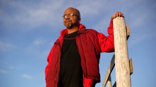 Lateef Dowdell stands on land once belonging to his uncle Gil Alexander, who was the last active Black farmer in the community of Nicodemus, Kan., Thursday, Jan. 14, 2021. Dowdell moved back to Nicodemus, a settlement founded by former slaves known as "exodusters" in the 1870s, several years earlier to take over the farm after his uncle died, but soon after lost most of the land when the bank foreclosed. New legislation in Congress aims to remedy historical inequities in government farm programs that have helped reduce the number of Black farmers in the United States from about a million in 1920 to less than 50,000 today.