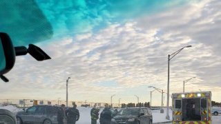 Chicago police vehicles and firefighters surround a car where a CPD officer helped deliver a baby outside of O'Hare Airport on Valentine's Day