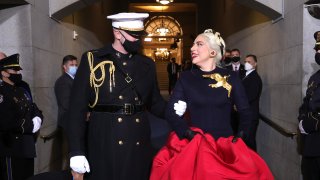 In this Jan. 20, 2021, file photo, Lady Gaga is escorted by U.S. Marine escort Capt. Evan Campbell to sing the National Anthem at the inauguration of U.S. President-elect Joe Biden on the West Front of the U.S. Capitol in Washington, D.C.