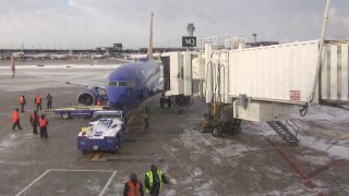 A blue Southwest Airlines jet pulls up to a gate at Chicago's O'Hare Airport on Sunday