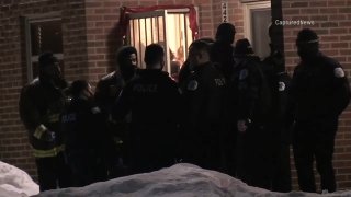 Chicago police stand outside of a residence in the city's Bronzeville neighborhood after a man attacked a woman and two children with a knife