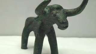 an ancient bronze bull figurine