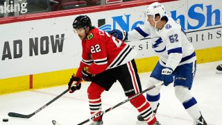 Mar 4, 2021; Chicago, Illinois, USA; Chicago Blackhawks center Ryan Carpenter (22) skates with the puck against Tampa Bay Lightning defenseman Cal Foote (52) during the first period at the United Center. Mandatory Credit: Mike Dinovo-USA TODAY Sports