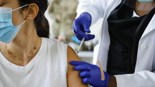 In this March 10, 2021, file photo, a healthcare administers a dose of the Pfizer-BioNTech COVID-19 vaccine at a vaccination center at the Miami Dade College North Campus in North Miami, Florida.