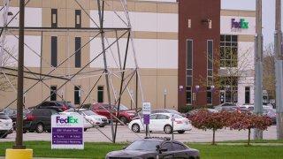 A sheriff's car blocks the entrance to the FedEx facility in Indianapolis, Saturday, April 17, 2021