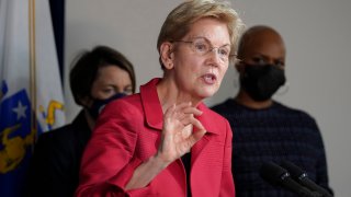 Sen. Elizabeth Warren, D-Mass., responds to questions from reporters as Mass. Attorney General Maura Healey, left, and Rep. Ayanna Pressley, D-Mass., right, look on during a news conference Thursday, April 1, 2021, in Boston. The news conference was held to call on President Biden to use the Higher Education Act to cancel a share of student loan debt for students with federal loans.