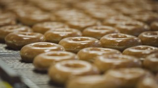 Doughnuts on a production line inside a Krispy Kreme Doughnuts Inc. store in the Times Square neighborhood of New York, U.S., on Thursday, Sept. 10, 2020. The 4,500-square-foot tourist attraction has a glaze waterfall, a 24-hour street-side pickup window, exclusive merchandise and a doughnut-making theater that produces 4,560 doughnuts an hour. Photographer: Angus Mordant/Bloomberg via Getty Images