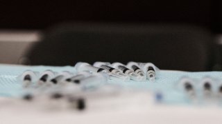 DETROIT, MI – APRIL 12: Doses of the Johnson and Johnson COVID-19 vaccine are prepared during a pop-up clinic at Western International High School on April 12, 2021 in Detroit, Michigan. The state of Michigan has seen an explosion of COVID-19 cases despite a massive effort to roll out vaccines. Pop-up clinics in various communities are one of the ways the state government is trying to get the surge under control. (Photo by Matthew Hatcher/Getty Images)
