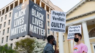 People carry signs after the verdict is announced in the trial of former Minneapolis police officer Derek Chauvin in Black Lives Matter Plaza in Washington, D.C., U.S., on April 20, 2021. Former Minneapolis police officer Derek Chauvin was found guilty of killing George Floyd when he knelt on the mans neck for 9 minutes and 29 seconds, a videotaped death that ignited a summer of rage and the greatest racial reckoning in the U.S. since the 1960s.