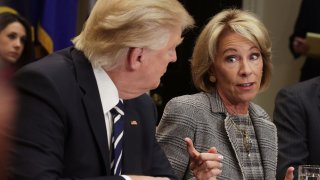 In this file photo, U.S. Secretary of Education Betsy DeVos (R) speaks as President Donald Trump (L) listens during a parent-teacher conference listening session at the Roosevelt Room of the White House February 14, 2017 in Washington, DC.