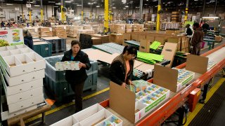 Employees assemble Lunch Blox food containers to packaged on a production line at the Newell Rubbermaid Inc. factory in Mogadore, Ohio.