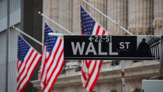 The Wall Street sign is seen outside The New York Stock Exchange (NYSE) in New York, February 16, 2021.