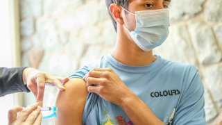 A young man receives his Covid-19 vaccination