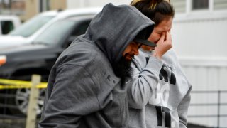 COLORADO SPRINGS, COLORADO - MAY 9: Freddy Marquez, left, walks walks his wife Nubia whose mother was one of six shooting victims, away from the scene of the shooting at the Canterbury Mobile Home Park on May 9, 2021 in Colorado Springs, Colorado. A gunman killed six people at a family birthday party before taking own life, police said. The victims were all members of the same extended family a party attendee said. The shooting was in the 2800 block of Preakness Way in the Canterbury Mobile Home Park. The shooting happened just after midnight. Colorado Springs police Lt. James Sokolik said in a news release. Investigators believe the shooter, who has not been publicly identified, was the boyfriend of a woman at the party.