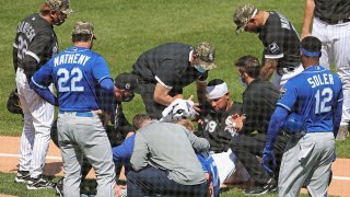 CHICAGO, ILLINOIS – MAY 14: Jose Abreu #79 of the Chicago White Sox and Hunter Dozier #17 of the Kansas City Royals are attended to after a hard collision in the 2nd inning at Guaranteed Rate Field on May 14, 2021 in Chicago, Illinois. (Photo by Jonathan Daniel/Getty Images)