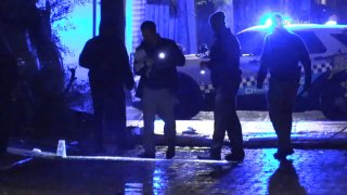 Chicago police canvass the scene where a 14-year-old boy was shot and killed in East Garfield Park on May 8, 2021.