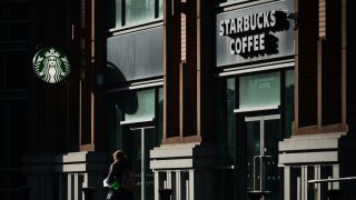 A person walks past a Starbucks Coffee in Dublin city center.