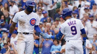 CHICAGO, ILLINOIS – JUNE 20: Jason Heyward #22 of the Chicago Cubs is congratulated by Javier Baez #9 after scoring during the third inning of a game against the Miami Marlins at Wrigley Field on June 20, 2021 in Chicago, Illinois. (Photo by Nuccio DiNuzzo/Getty Images)